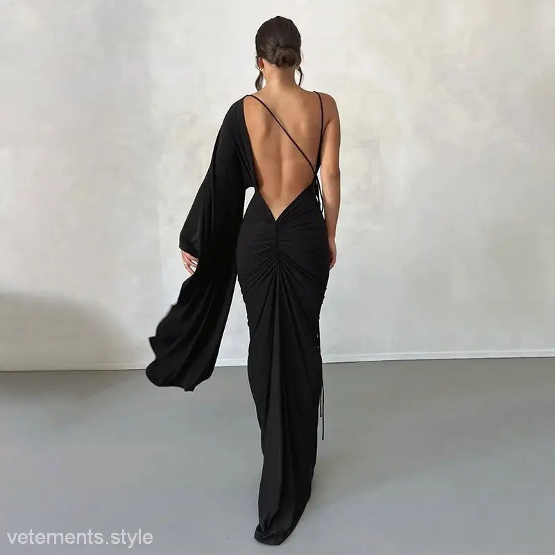 Elegant black backless evening dress with low cut and ruched detailing for a sexy look