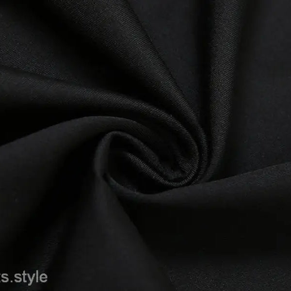 Black fabric in spiral fold design showcasing a sexy low cut backless evening dress