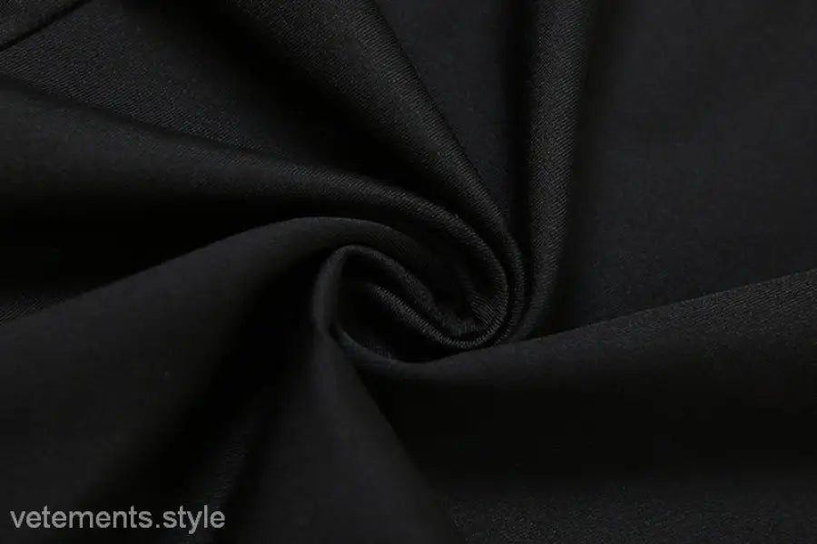 Black fabric in spiral fold design showcasing a sexy low cut backless evening dress
