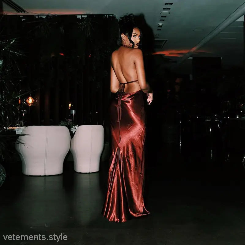 Elegant halter backless satin maxi dress featuring a shimmering, floor-length design