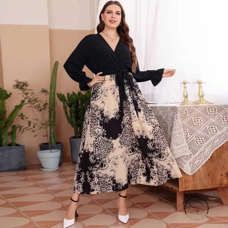 Elegant black and cream floral v-neck maxi dress with bell sleeves and tie waist