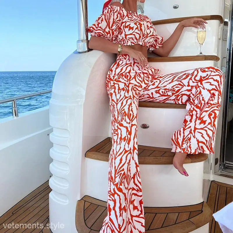 Woman in stylish red and white off-shoulder set on a boat, featuring free shipping