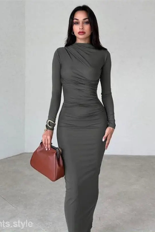 Elegant bodycon dress in dark grey featuring long sleeves and ruching detail for parties