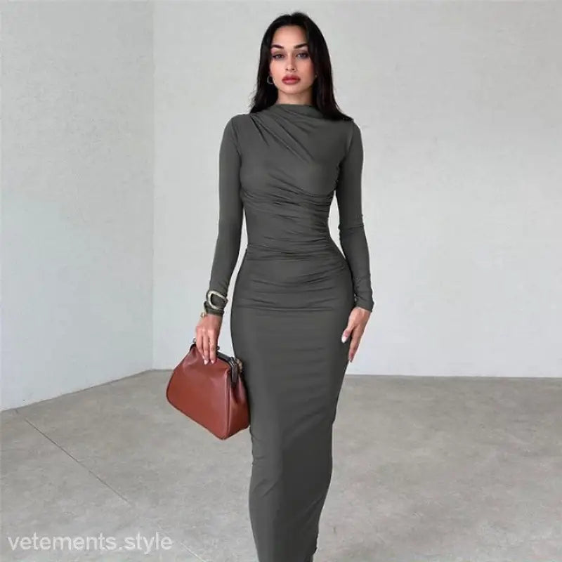 Elegant bodycon dress in dark grey featuring long sleeves and ruching detail for parties