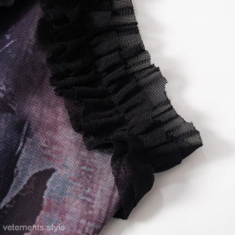 Sheer black mesh fabric with ruffled edges and purple undertone in Elegant Pleated Lace Dress