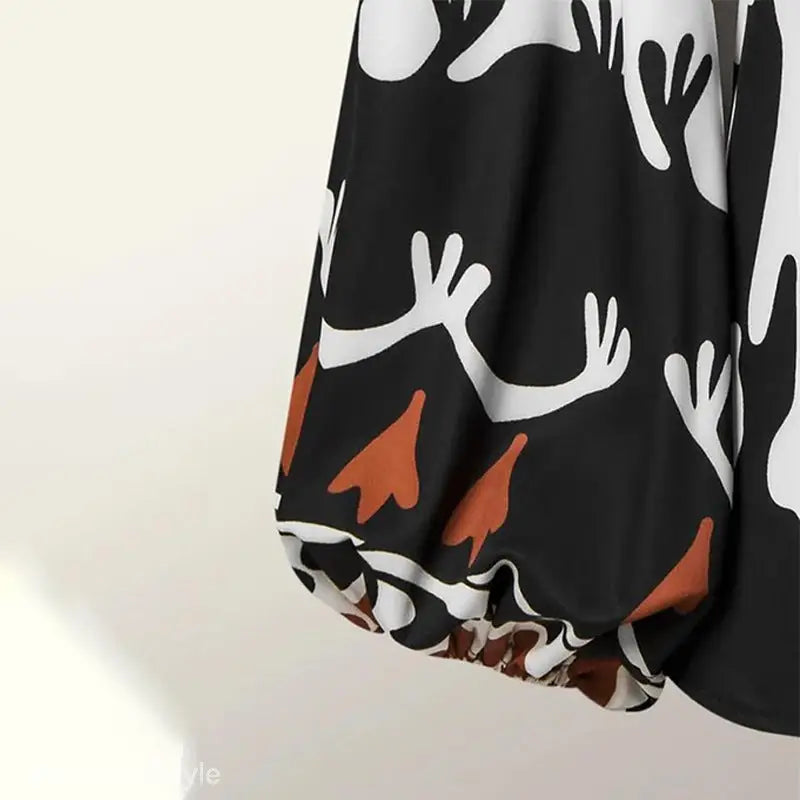 Elegant bohemian contrast casual two-piece set featuring a black puff-sleeve top with white abstract branch patterns and rust leaf designs