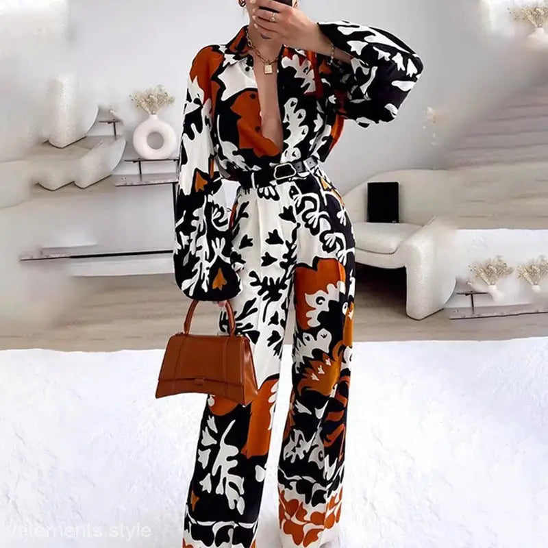 Elegant bohemian contrast long-sleeved jumpsuit with deep V-neck and abstract color pattern