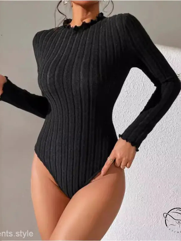 Black ribbed long-sleeve bodysuit with ruffled neckline, perfect for brushed striped jumpsuit styling