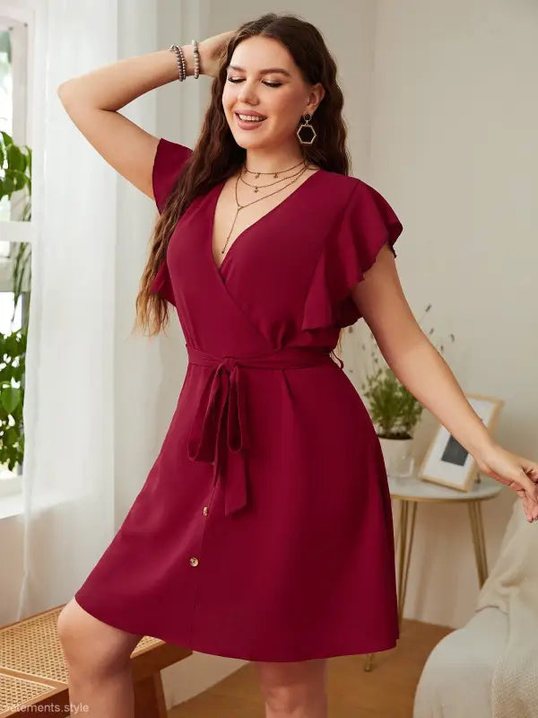 Burgundy butterfly sleeve dress featuring a loose fit and elegant ruffle details