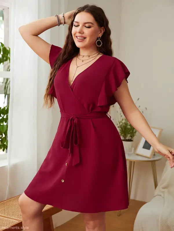 Burgundy butterfly sleeve dress featuring a loose fit and elegant ruffle details