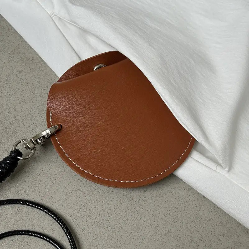 Brown leather semicircular pouch with white stitching for elegant casual hem stitching dress