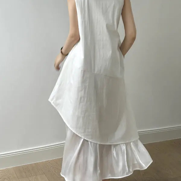 White sleeveless hem stitching dress featuring a ruffled asymmetrical hem and pocket