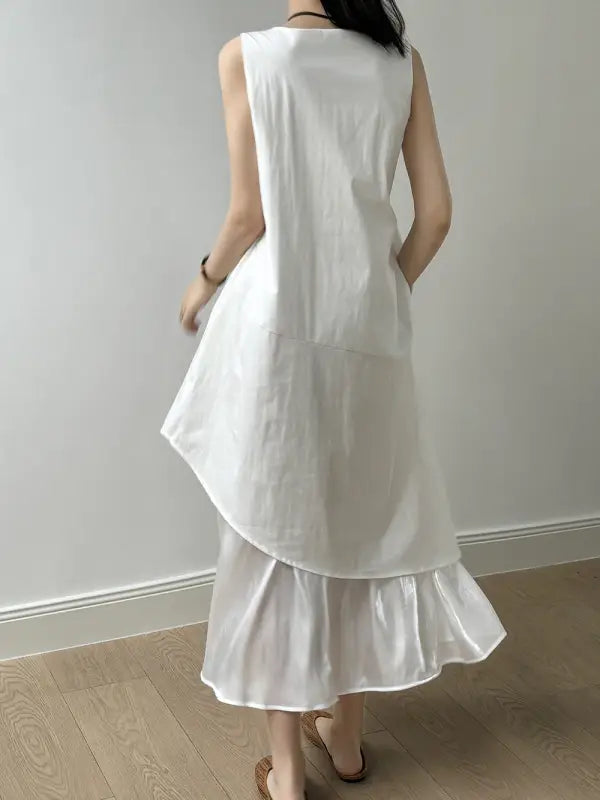 White sleeveless hem stitching dress featuring a ruffled asymmetrical hem and pocket