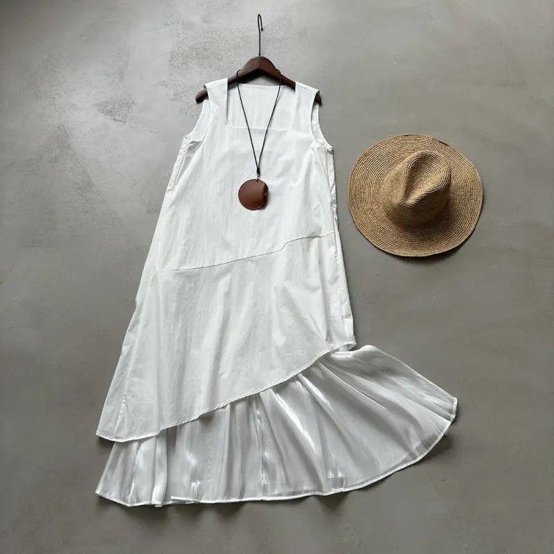 White asymmetrical sleeveless hem stitching dress featuring layered ruffle hem, pocket, and zipper