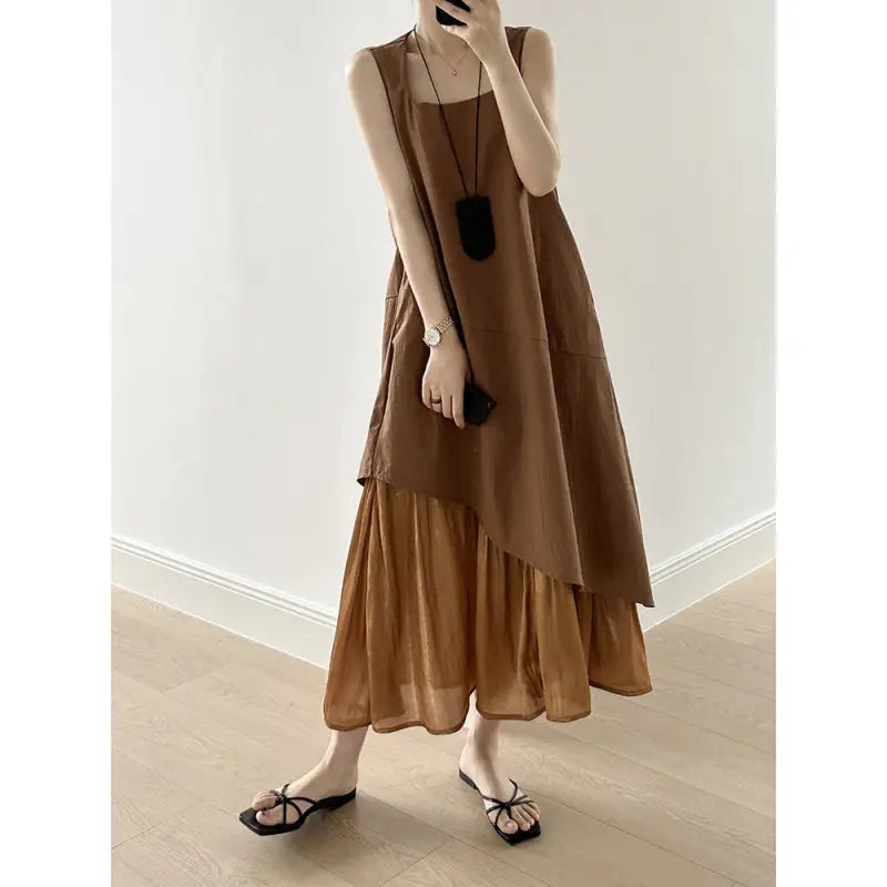 Layered brown sleeveless hem stitching dress with asymmetrical hem and flat sandals