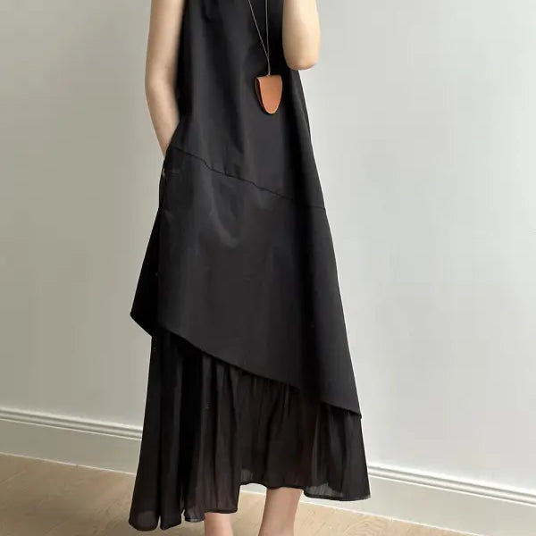 Asymmetrical black layered hem stitching dress with wide straps and elegant necklace