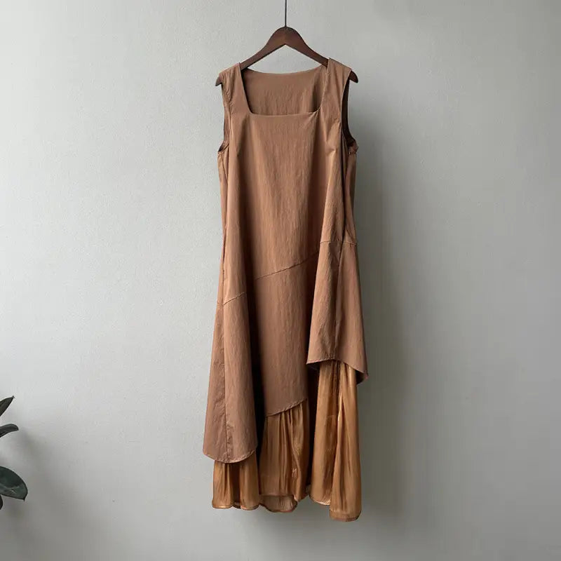 Sleeveless caramel hem stitching dress with ruffled layers on a wooden hanger
