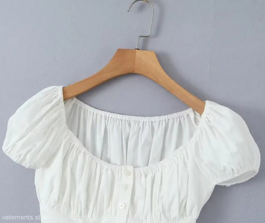 White puff-sleeve blouse on hanger from elegant casual skirt set, ideal for casual beach outfits