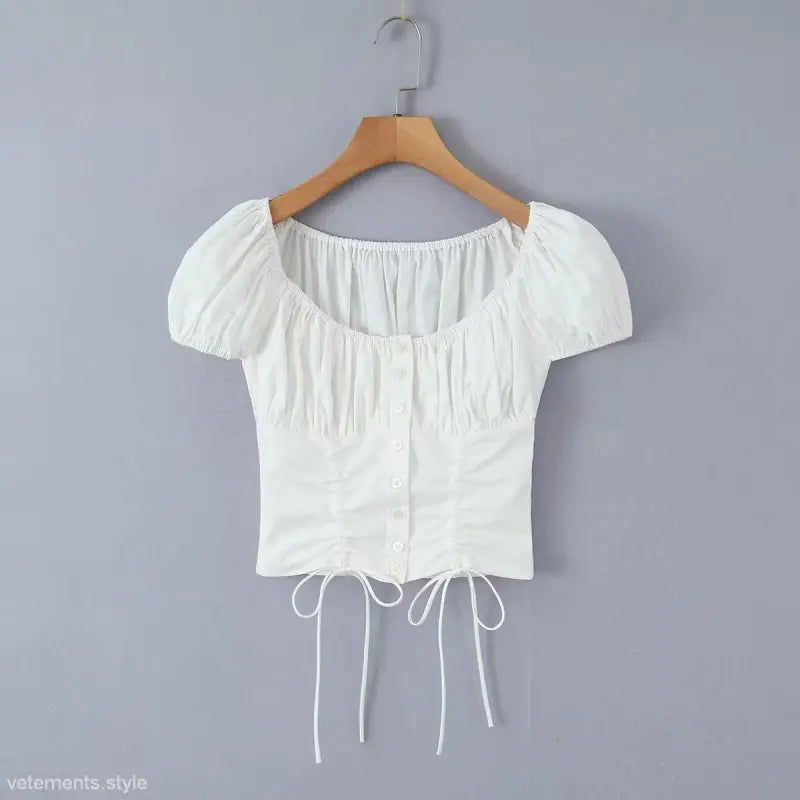 White short-sleeved cinched crop top from elegant casual skirt set, ideal for casual beach outfits