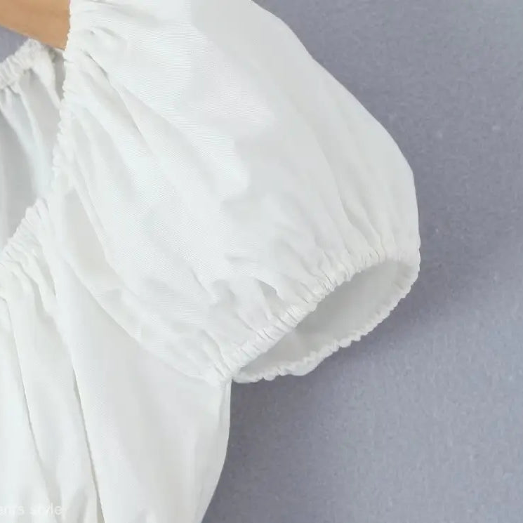 White puff-sleeve blouse from casual skirt set, ideal for summer beach outfits