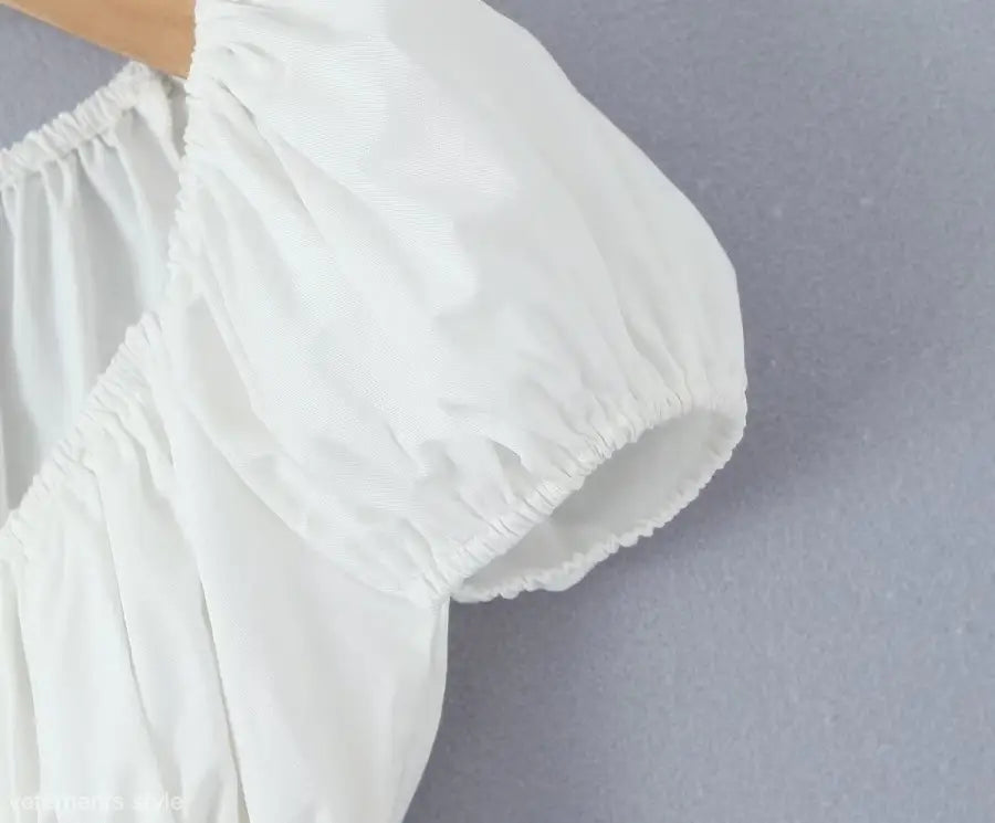 White puff-sleeve blouse from casual skirt set, ideal for summer beach outfits