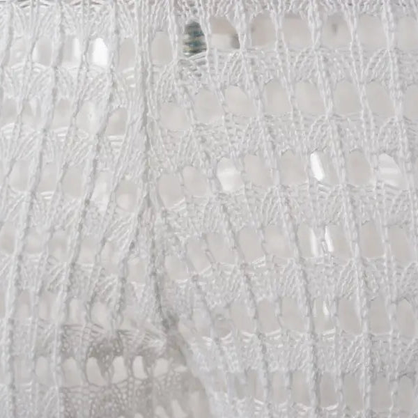 White sequined fabric detail on elegant cotton summer beach pants with lace and tulle