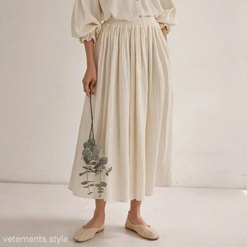 Cream-colored textured midi dress featuring lantern sleeves in the lantern sleeve niche design