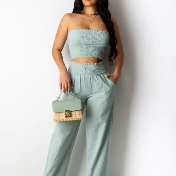 Woman in mint green strapless crop top and wide-leg pants, perfect for Berlin summer outfit
