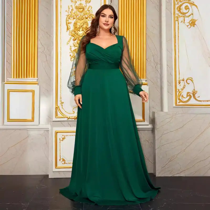 Elegant evening dress in emerald green with sheer sleeves and V-neck for formal events