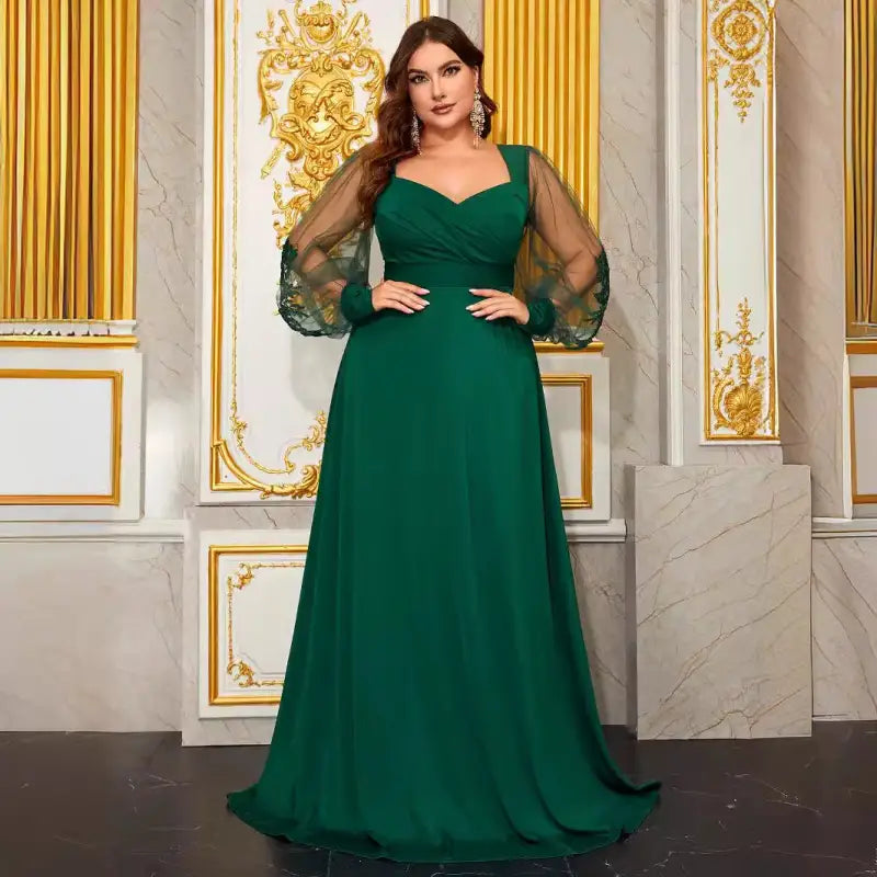 Elegant evening dress with emerald green color, sheer sleeves, and V-neck for formal events