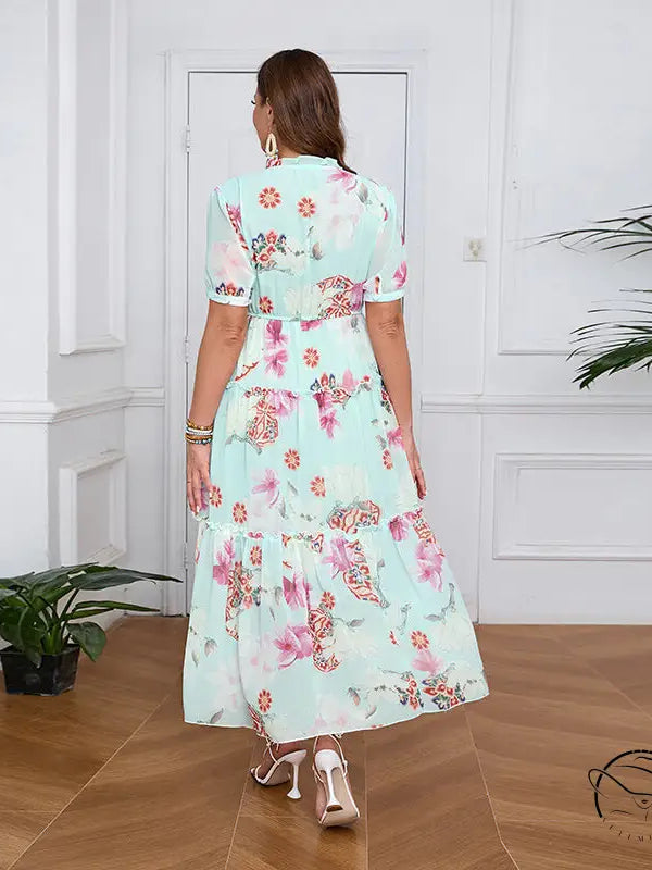 Elegant evening maxi dress in light green floral print with ruffles