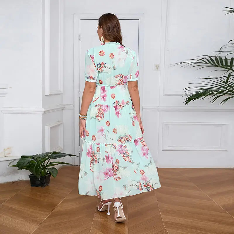 Elegant evening maxi dress with floral print, tiered skirt, and short puff sleeves