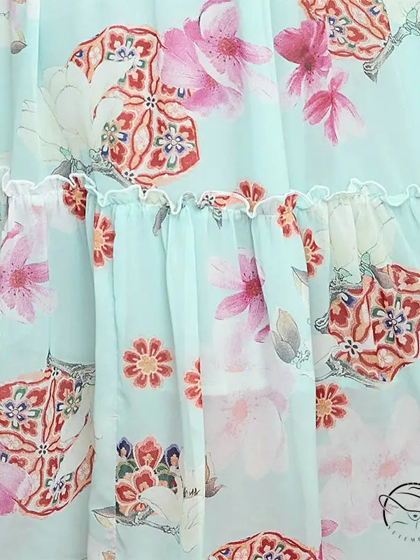 Elegant evening maxi dress in light blue floral print with ruffled seam