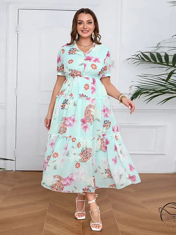Elegant evening maxi dress in mint green with floral butterfly print and ruffles