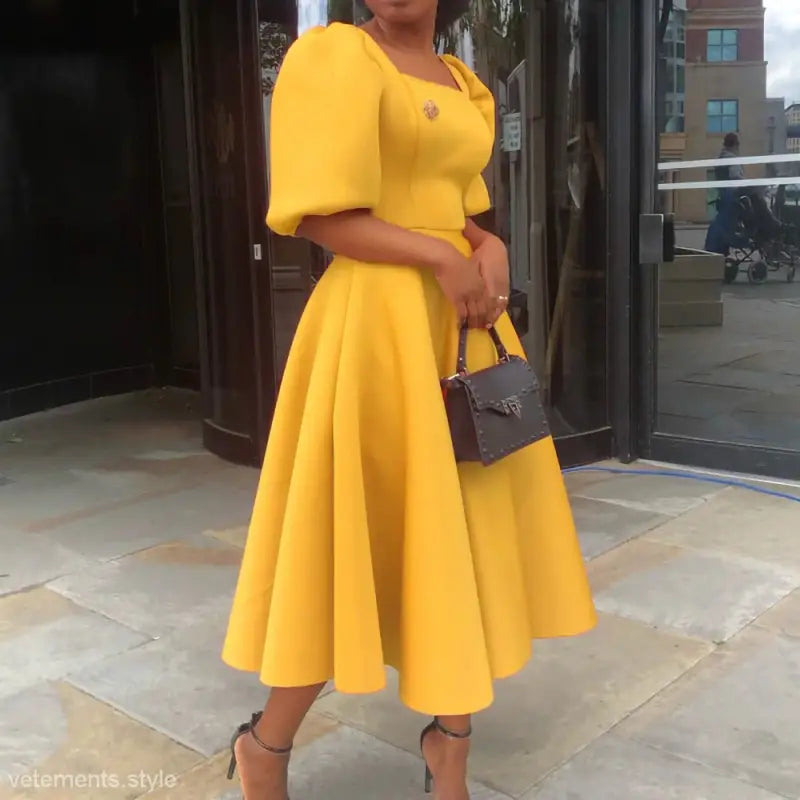 Elegant evening puff sleeve dress with vibrant yellow color, puff sleeves, and flared midi skirt