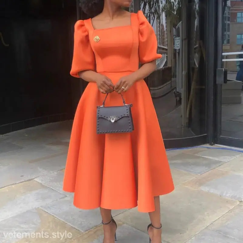 Elegant evening puff sleeve dress in vibrant orange with flared skirt and cotton fabric