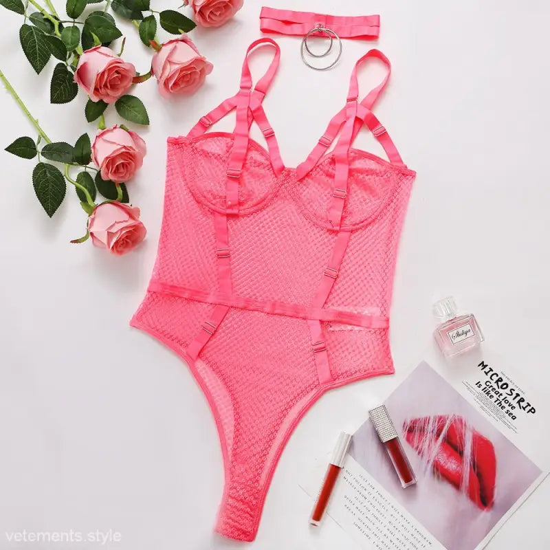 Pink lace bodysuit featuring adjustable straps and high-cut leg design for a sexy fishnet teddy