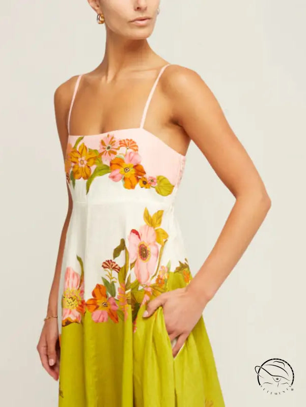 Floral sundress with spaghetti straps featuring a colorful pattern of flowers on a white, pink, and lime green background.