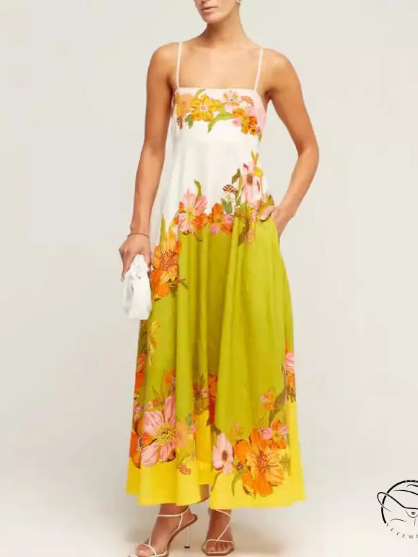 Floral print maxi dress with spaghetti straps and a white bodice transitioning to a lime green and yellow skirt.