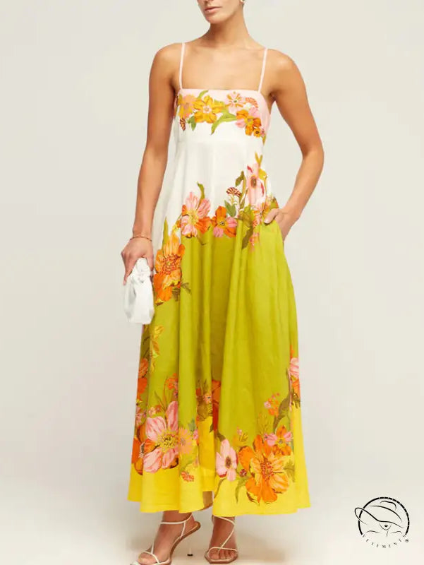 Floral maxi dress with spaghetti straps in white, lime green, and orange tones.