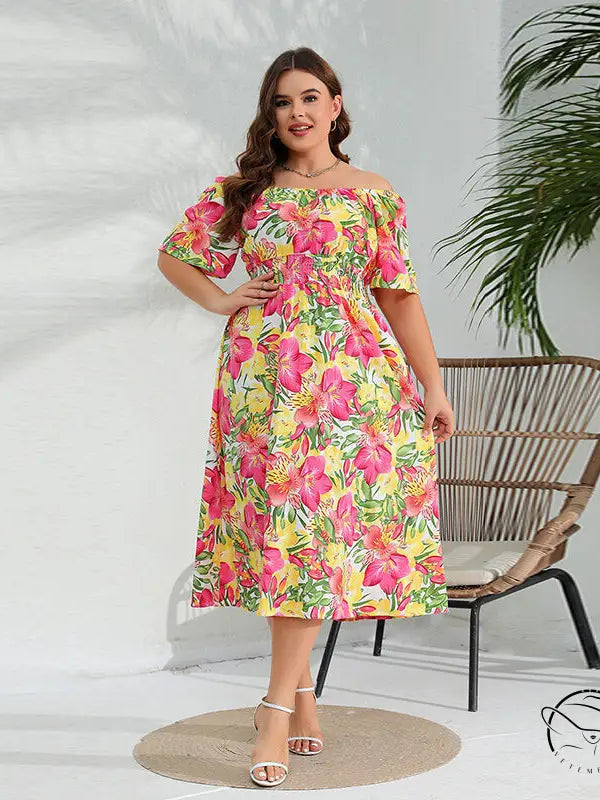 Elegant floral midi dress with vibrant pink, yellow, green print
