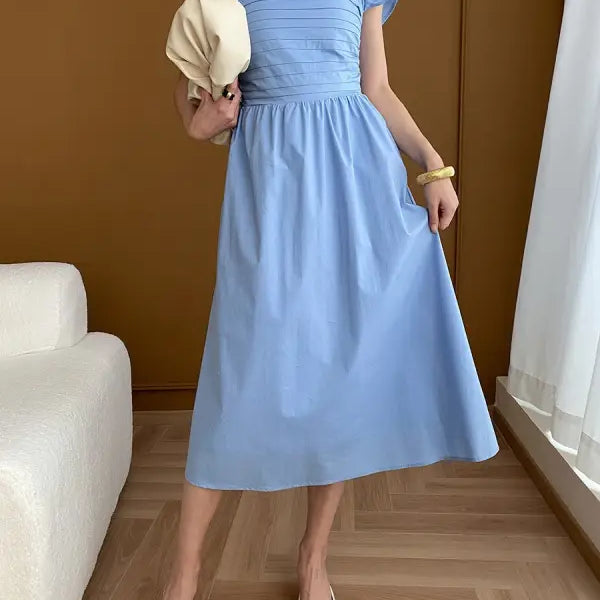Light blue midi dress styled with the Elegant Flying Dress featuring black ruffled details