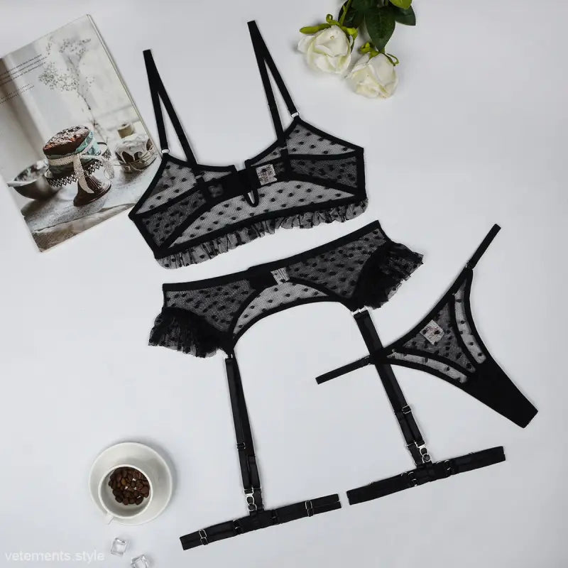 Black lace lingerie four piece set with polka dot pattern, featuring bra, panties, and garter belt
