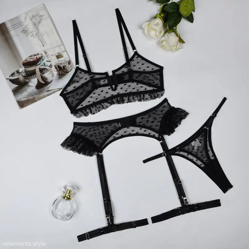 Elegant Four-Piece Lingerie Set featuring black lace bra, garter belt, and thong