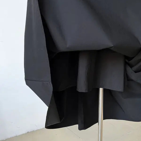 Black umbrella with a metal shaft partially visible.