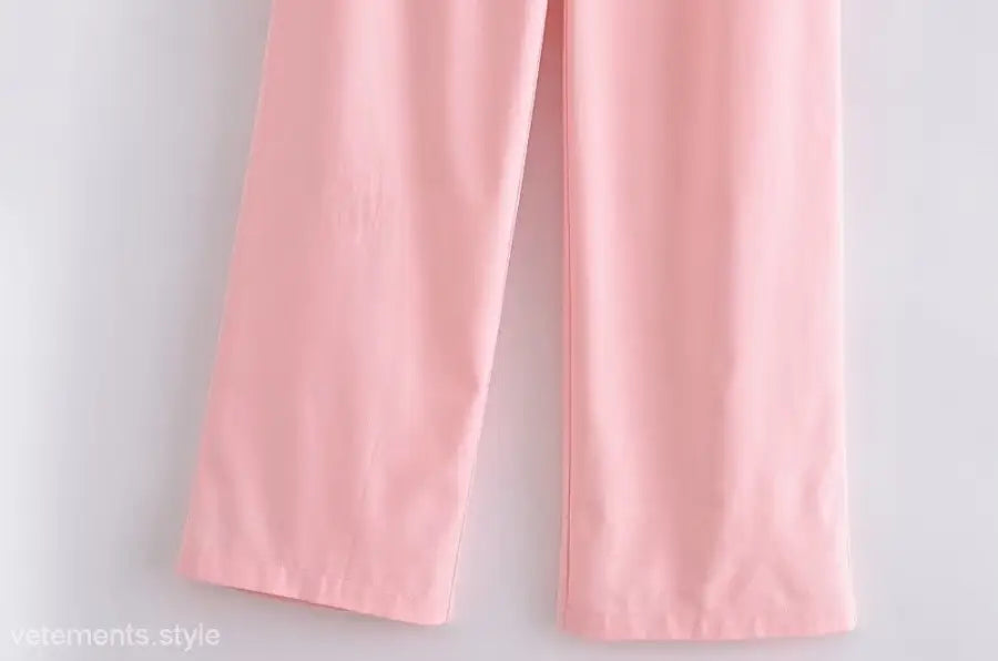 Elegant French style pink wide-leg pants displayed with a sleeveless V-neck polyester outfit