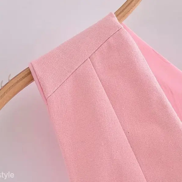 Pink garment on hanger showcasing elegant French style sleeveless V-neck polyester