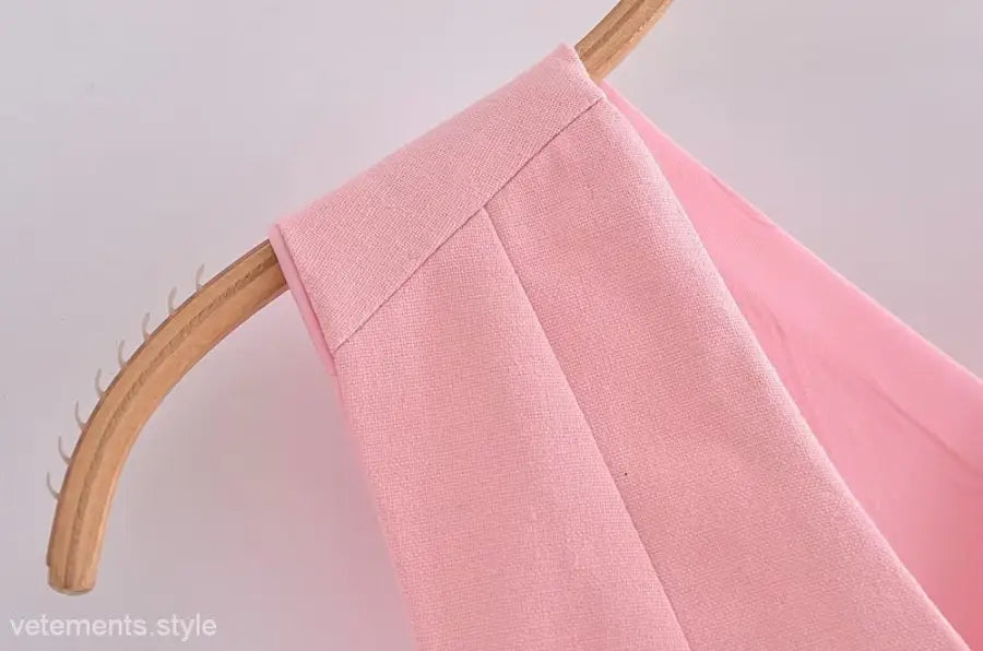 Pink garment on hanger showcasing elegant French style sleeveless V-neck polyester