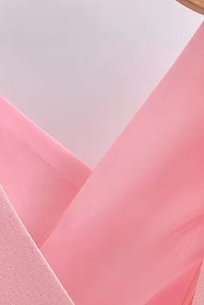 Pink v-neck top on hanger showcasing elegant French style sleeveless polyester design