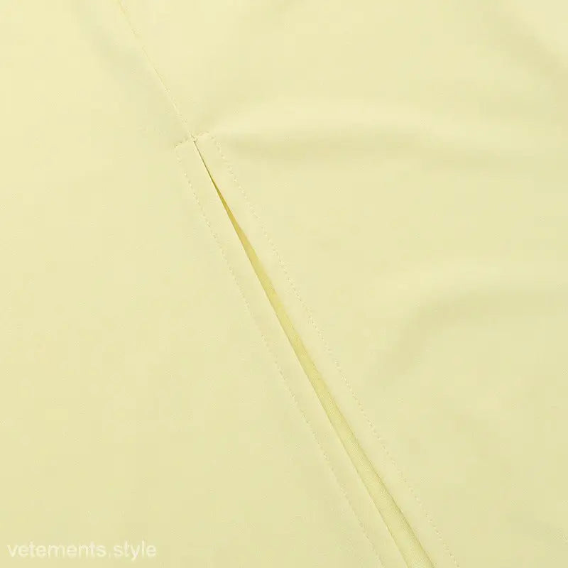 Thin diagonal line on a pale background of an Elegant Girdle Dress with Lace Accents